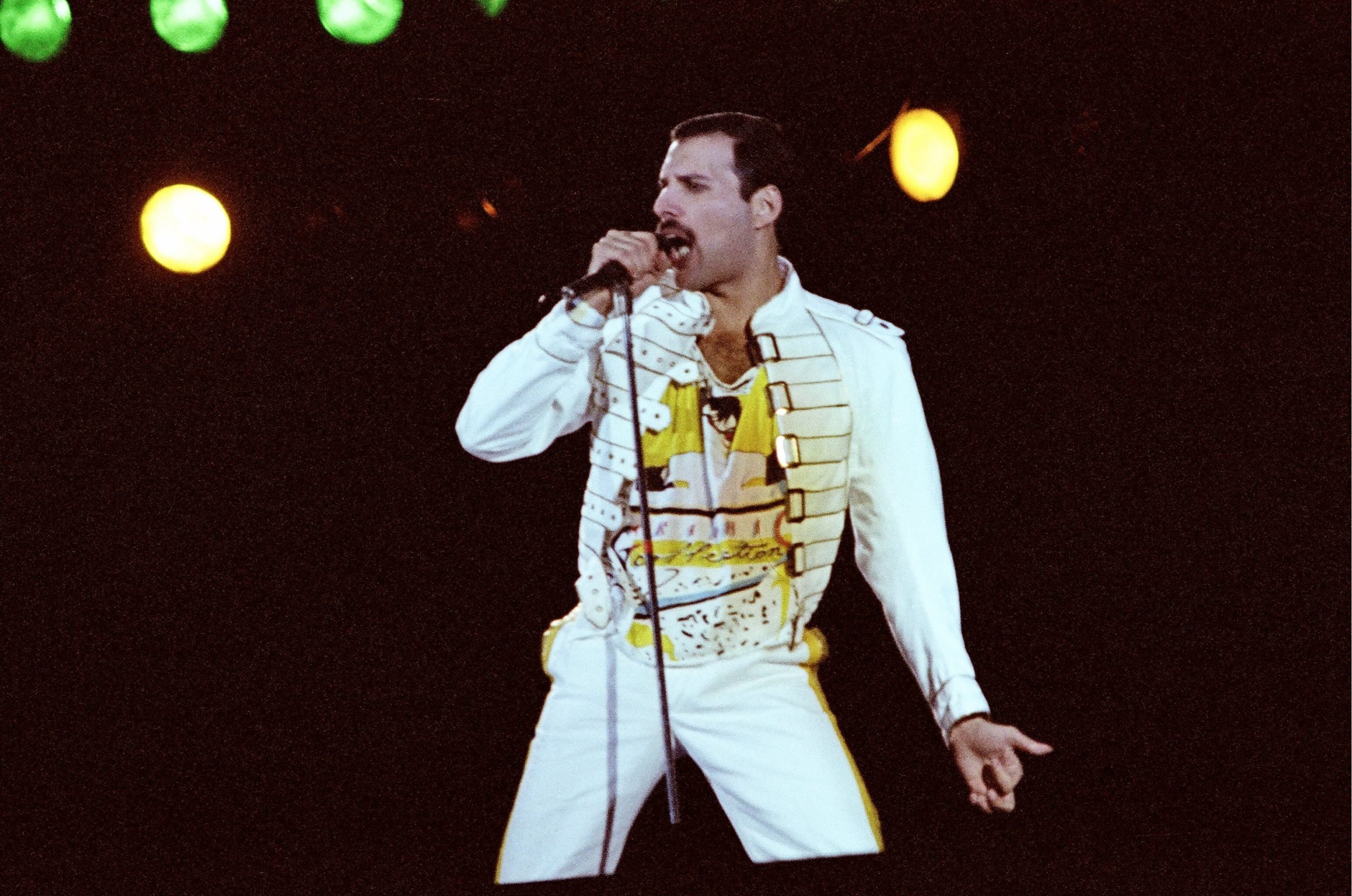 Queen's Freddie Mercury with a microphone during the "Somebody to Love" era