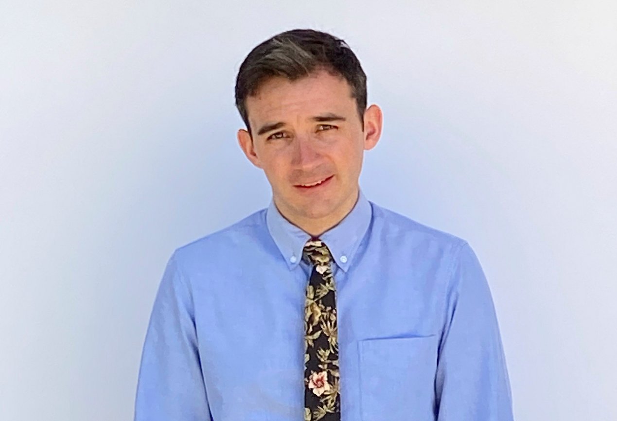 Ian Terry of 'Big Brother 22' stands in a blue shirt and tie.