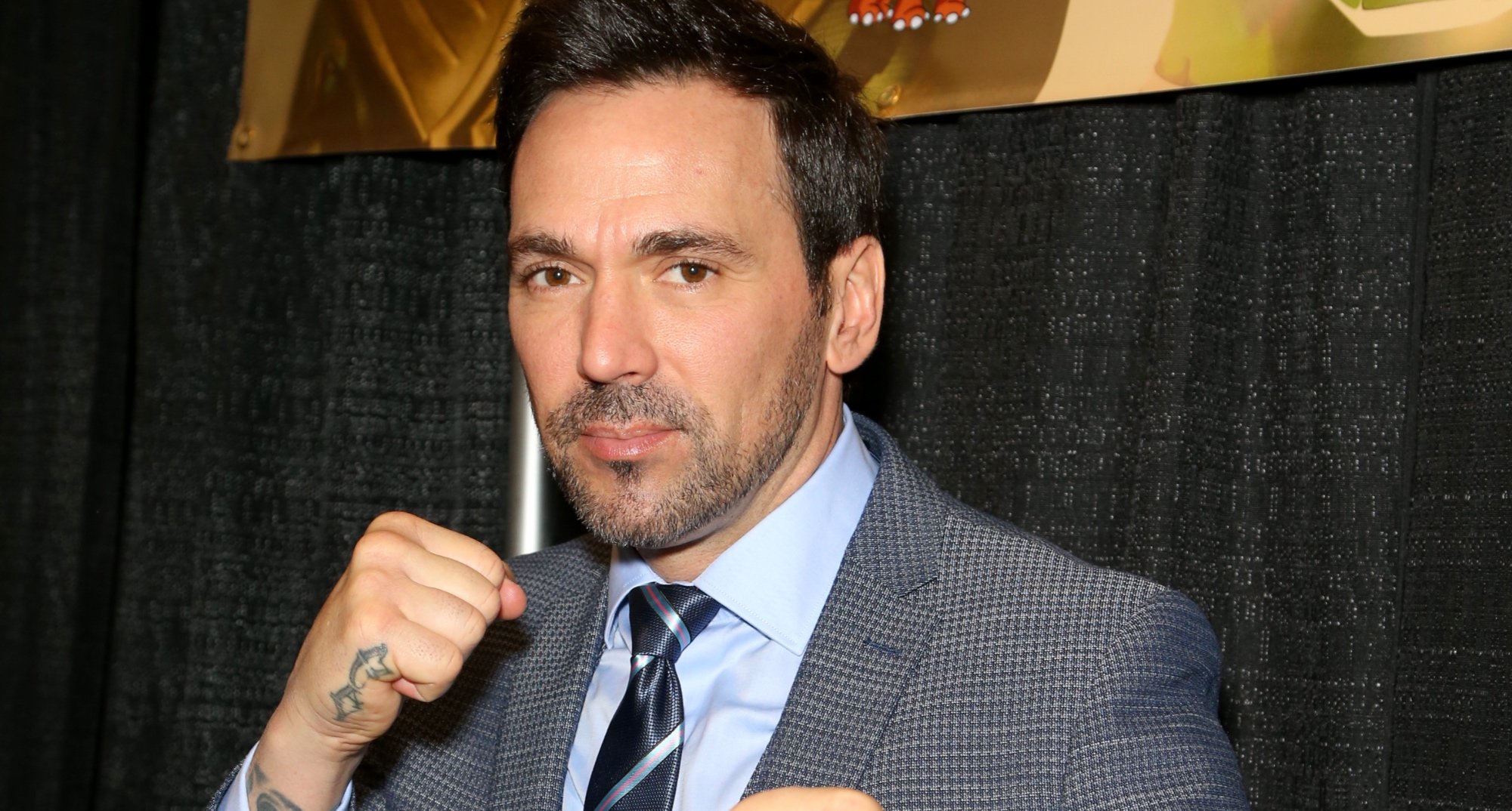 Jason David Frank played Tommy Oliver in 'Mighty Morphin Power Rangers' wearing grey suit.