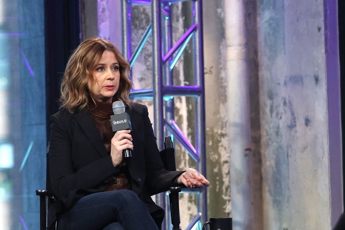 Jenna Fischer sitting down and speaking into a microphone.