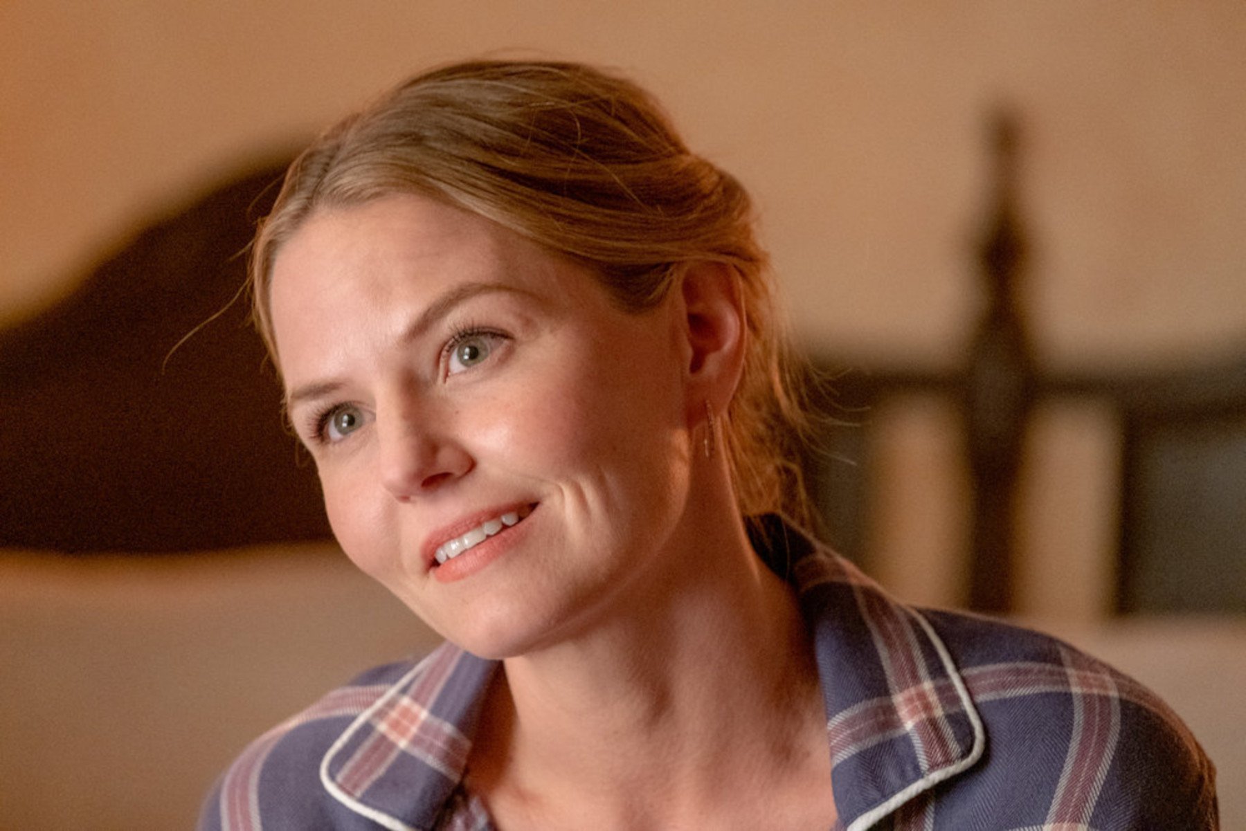 Jennifer Morrison as Cassidy Sharp in 'This Is Us' Season 6. She's wearing a plaid shirt, leaning forward, and smiling.