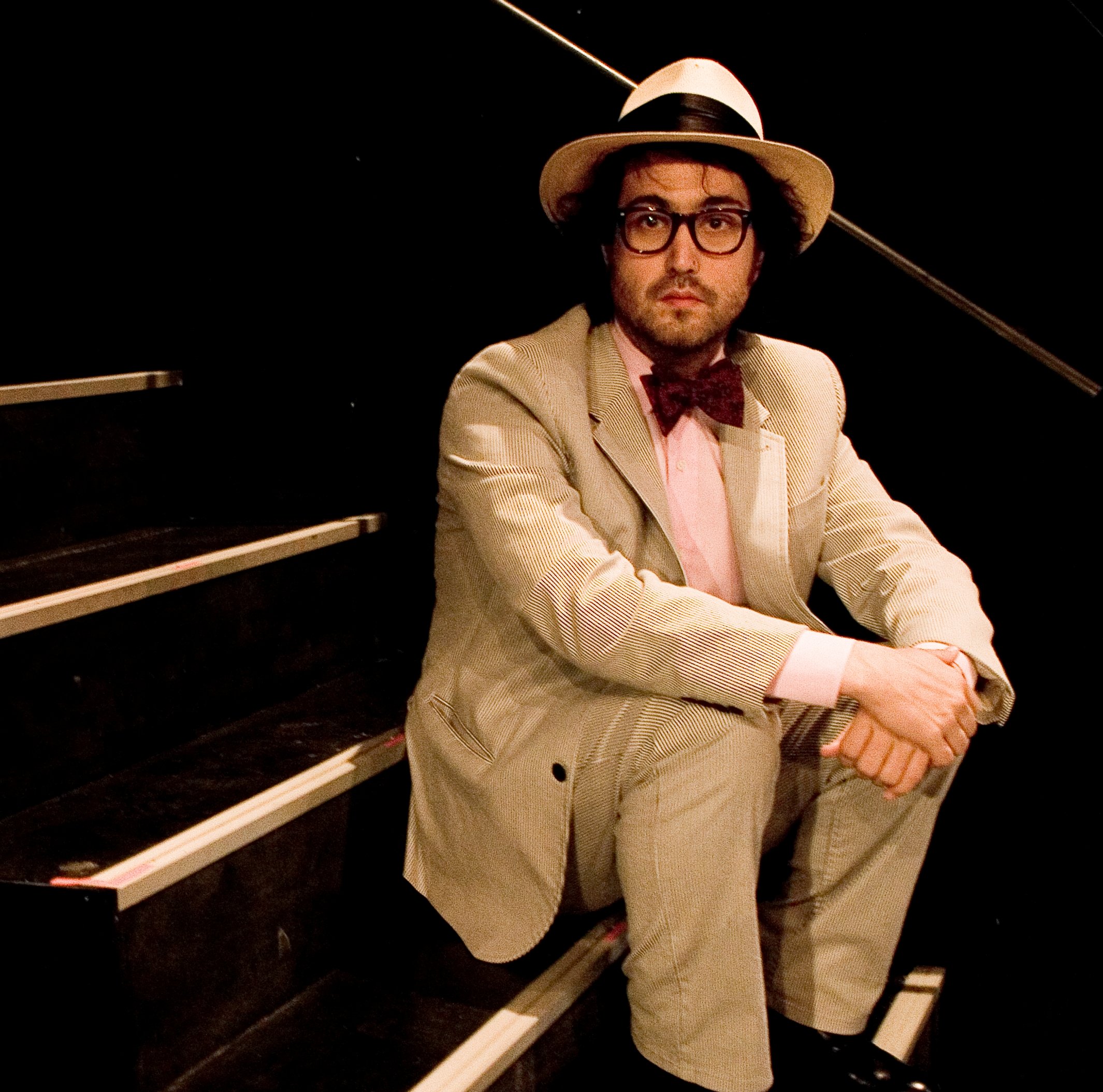 John Lennon’s son, Sean Ono Lennon, sitting on stairs