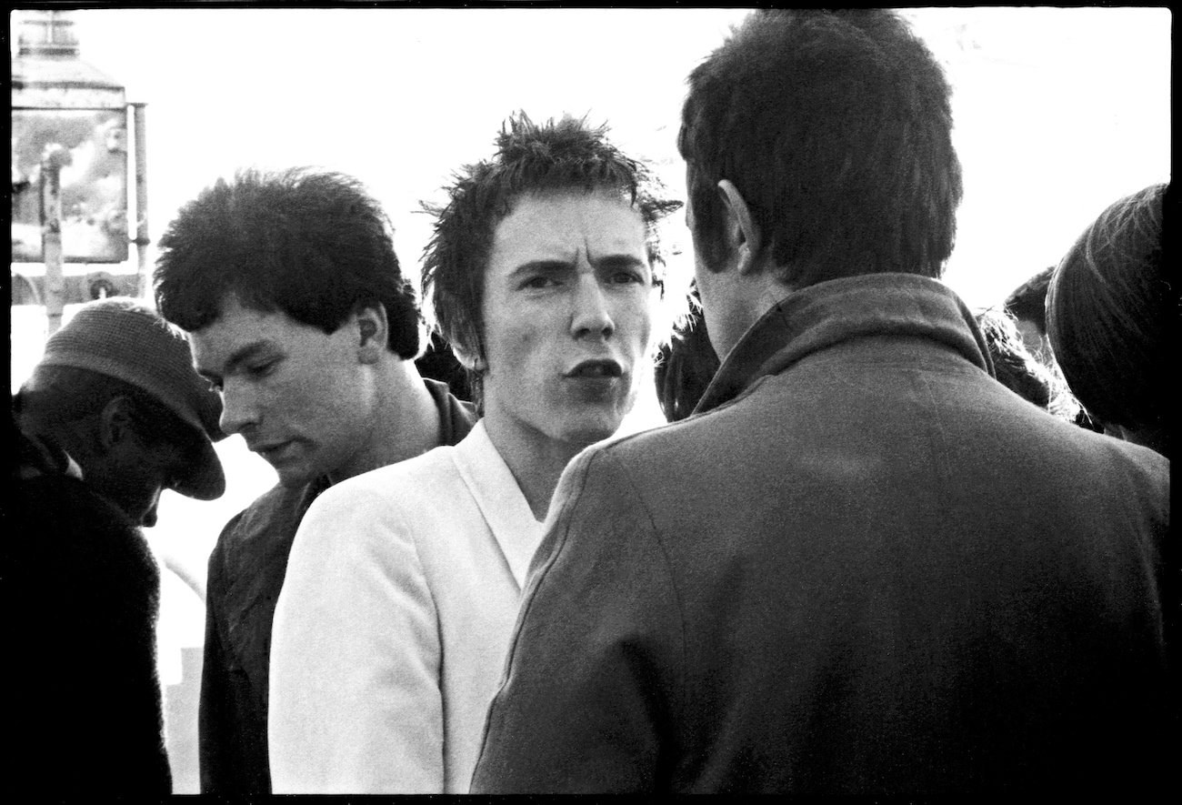 Johnny Rotten sailing with the Sex Pistols and friends on the Queen Elizabeth along the River Thames in 1977.