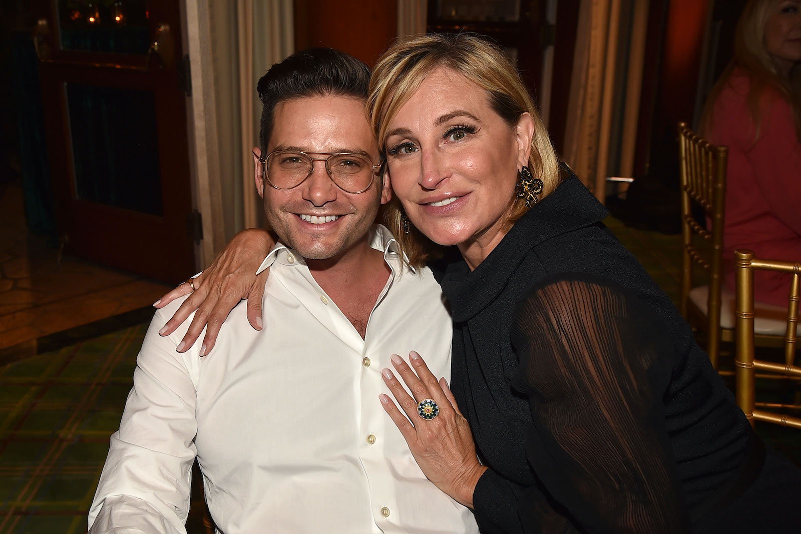 Josh Flagg and Sonja Morgan pose for a photo at a birthday party in 2021. 