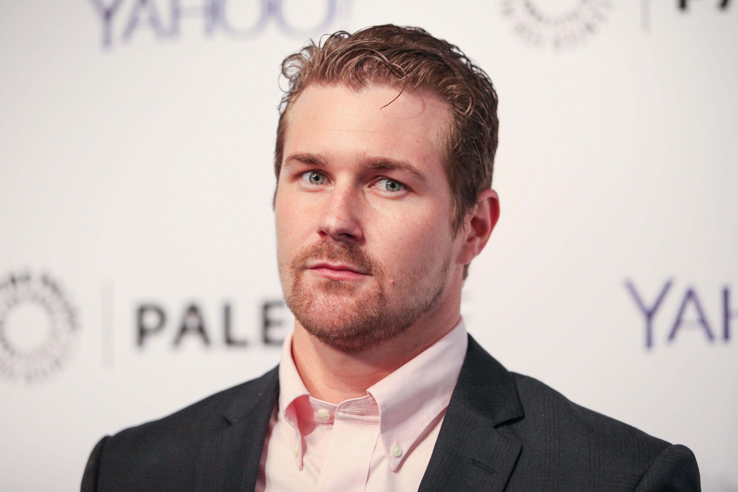 'General Hospital' actor Josh Kelly wearing a black suit and pink shirt.