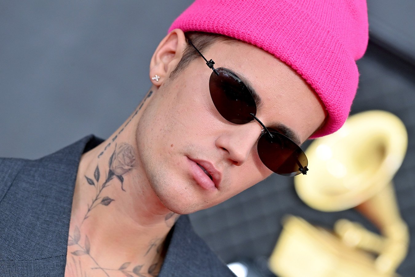 A close-up of Justin Bieber wearing a pink beanie and sunglasses. Justin Bieber was diagnosed with Ramsay Hunt Syndrome in 2022