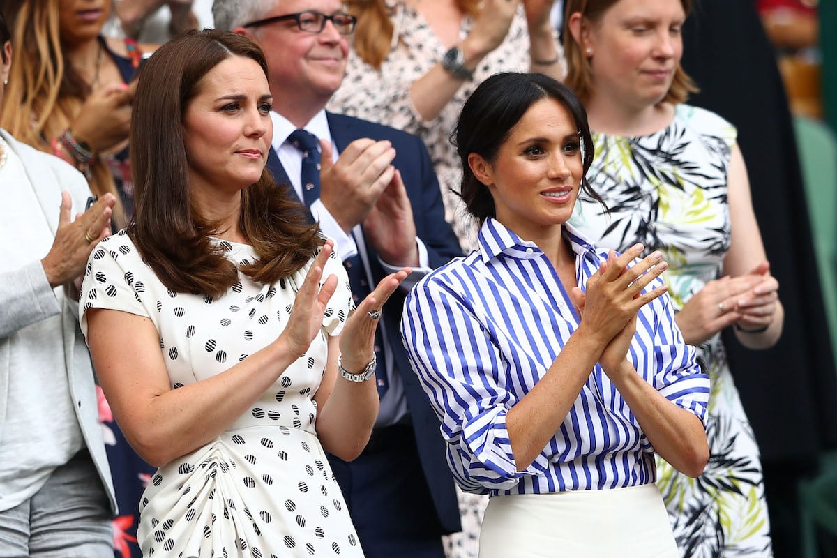 Kate Middleton and Meghan Markle stand and clap at Wimbledon tennis match