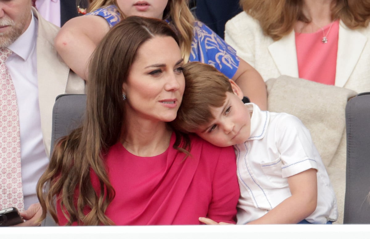 Kate Middleton, who spoke to Prince Louis, looks on as Prince Louis leans on her shoulder at the jubilee pageant