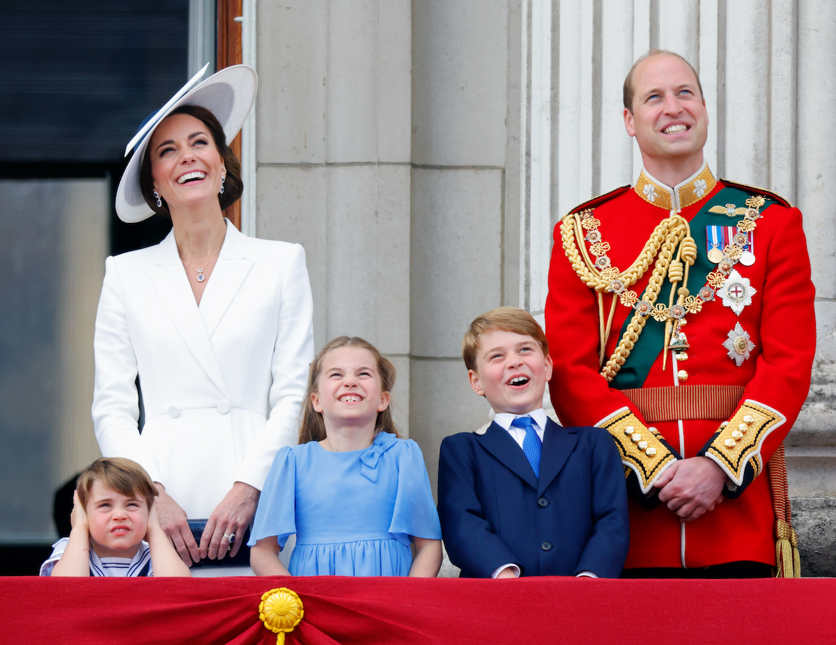 Kate Middleton, who spoke to Prince William upon seeing Prince Louis' balcony appearance, stands next to Prince William, Prince Louis, Princess Charlotte, and Prince George 