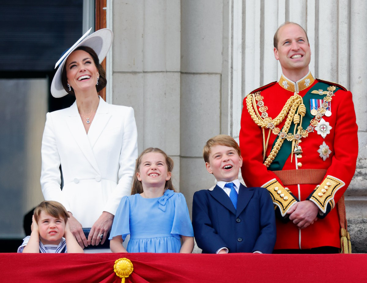 Kate Middleton, who spoke to Prince William upon seeing Prince Louis' balcony appearance, stands next to Prince William, Prince Louis, Princess Charlotte, and Prince George 