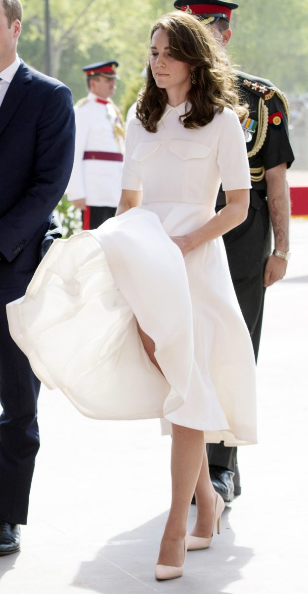 Kate Middleton trying to maintain her dress while visiting the India Gate Memorial