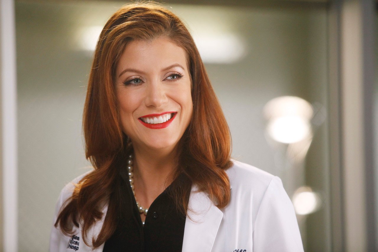 Kate Walsh as Addison Montgomery on 'Grey's Anatomy' smiles in a lab coat.