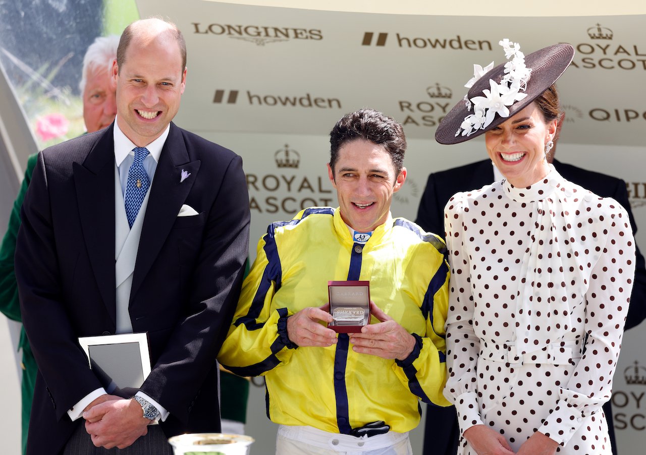 (l-r) Prince William, jockey Christophe Soumillon and Kate Middleton, in her signature pose, stand for pictures during a ceremony in 2022