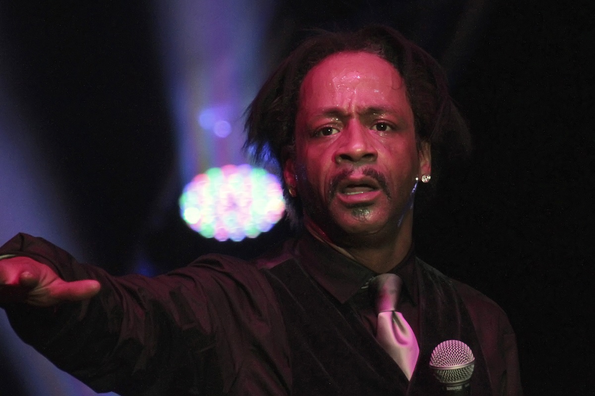 Katt Williams performing on stage while holding a microphone.