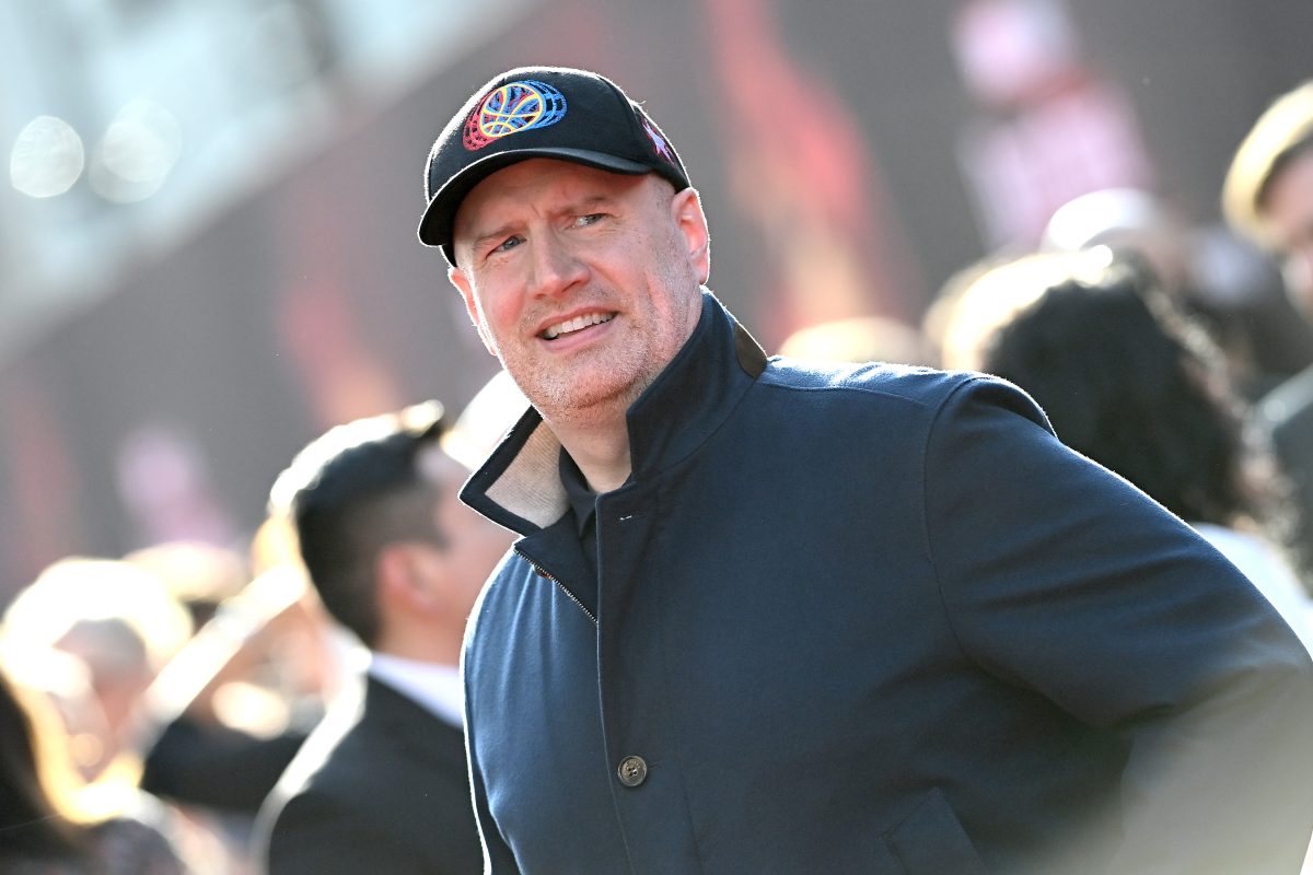 Kevin Feige, who is helming Phase 5 of the MCU, wears a black coat and a black baseball cap with the Doctor Strange symbol on it.
