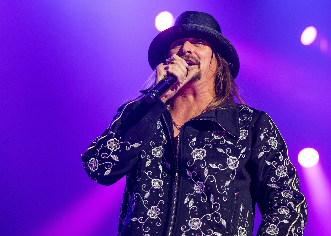 Kid Rock, seen here performing on stage in a black and white jacket, did not apologize for his comments about Oprah.