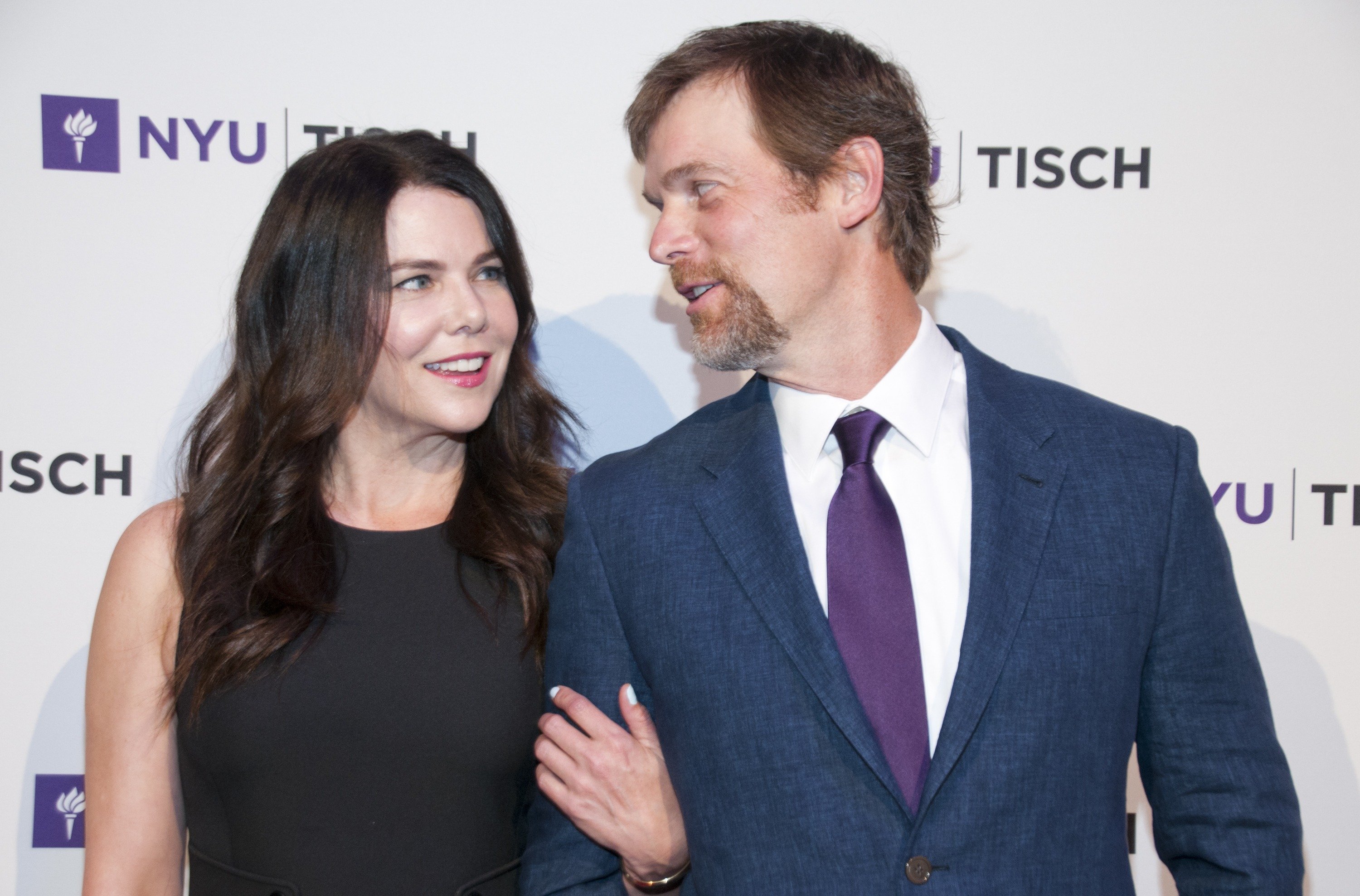 Lauren Graham and Peter Krause pose side by side and look at each other during an event at New York University.