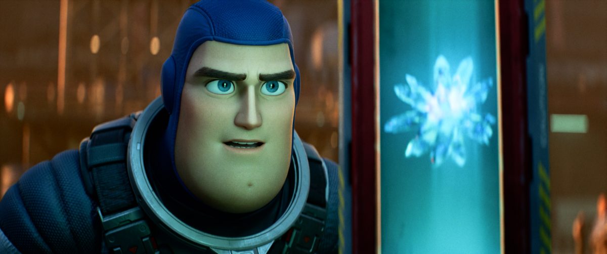 'Lightyear' Chris Evans as Buzz Lightyear, whose toy version is voiced by Tim Allen. Buzz is looking at a glowing crystal inside of a tube wearing his space ranger uniform.