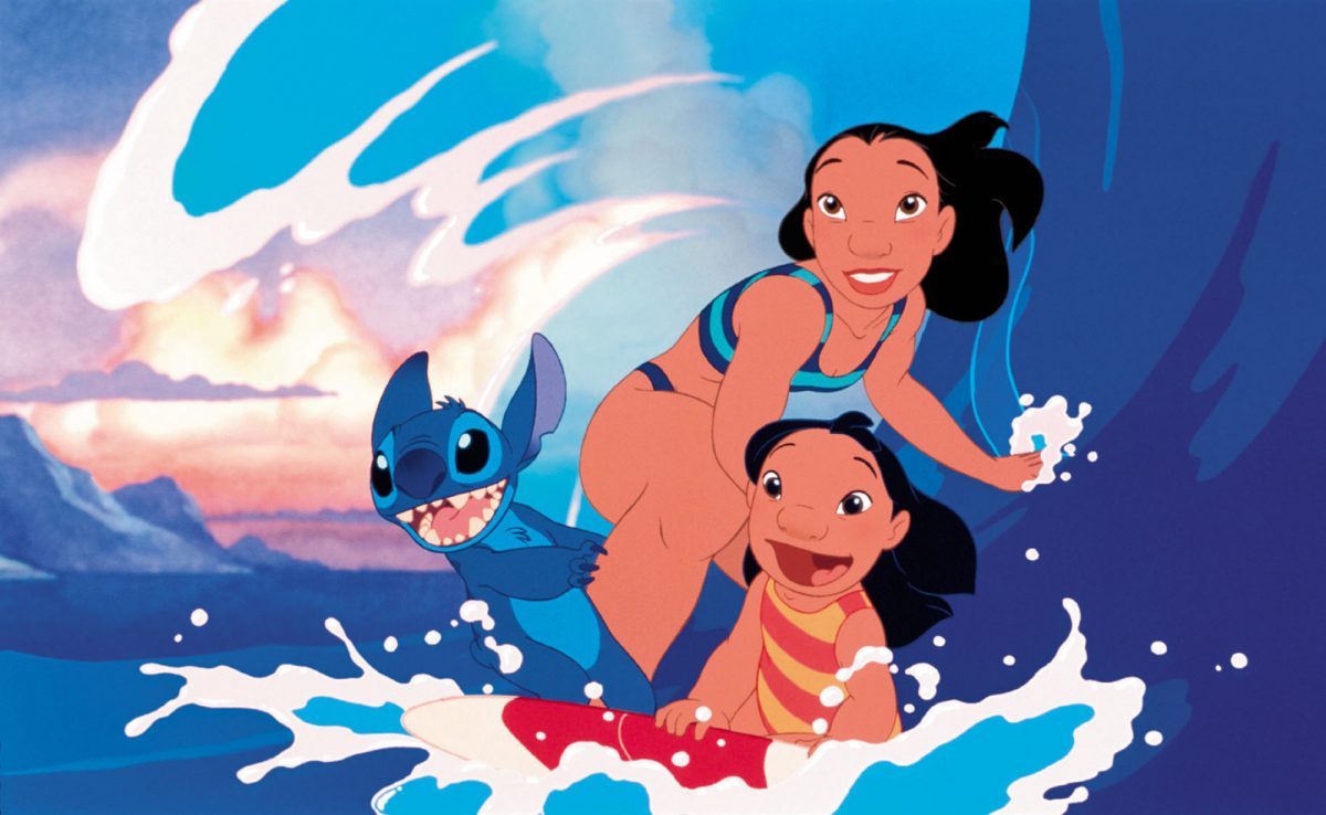 'Lilo & Stitch' Stitch (voiced by Chris Sanders), Nani (voiced by Tia Carrere), and Lilo (voiced by Daveigh Chase) riding on a surfboard together and smiling.