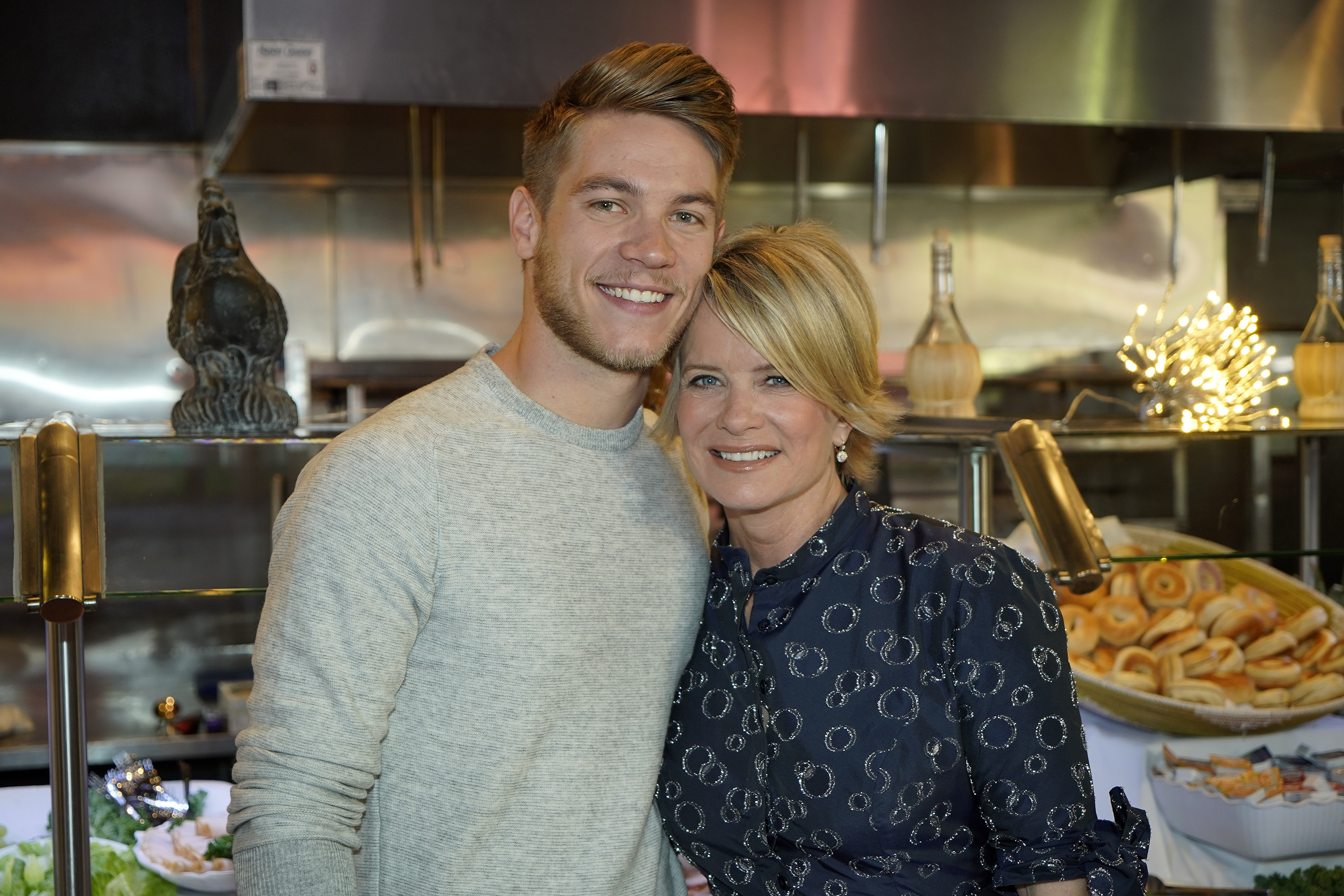 'Days of Our Lives' actors Lucas Adams and Mary Beth Evans posing together in a kitchen.