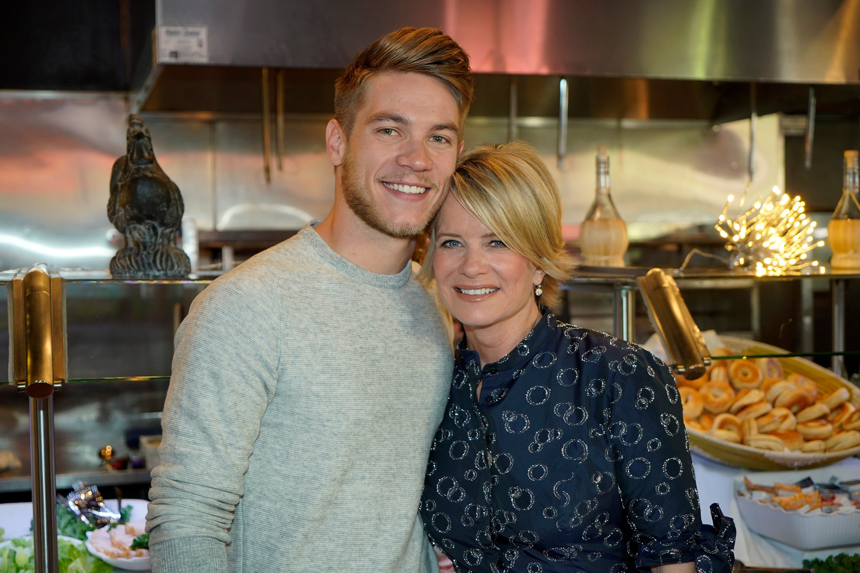 'Days of Our Lives' actors Lucas Adams and Mary Beth Evans posing together in a kitchen.