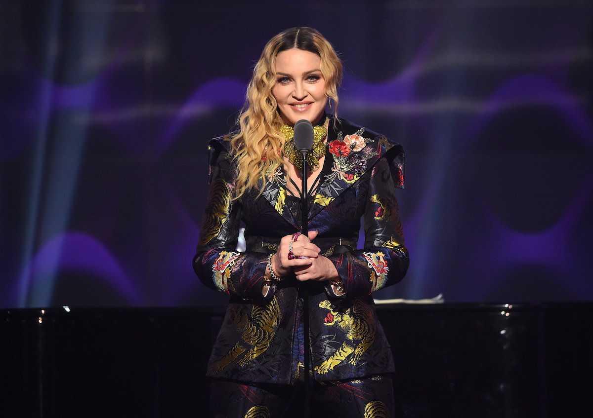 Madonna smiling, speaking on stage