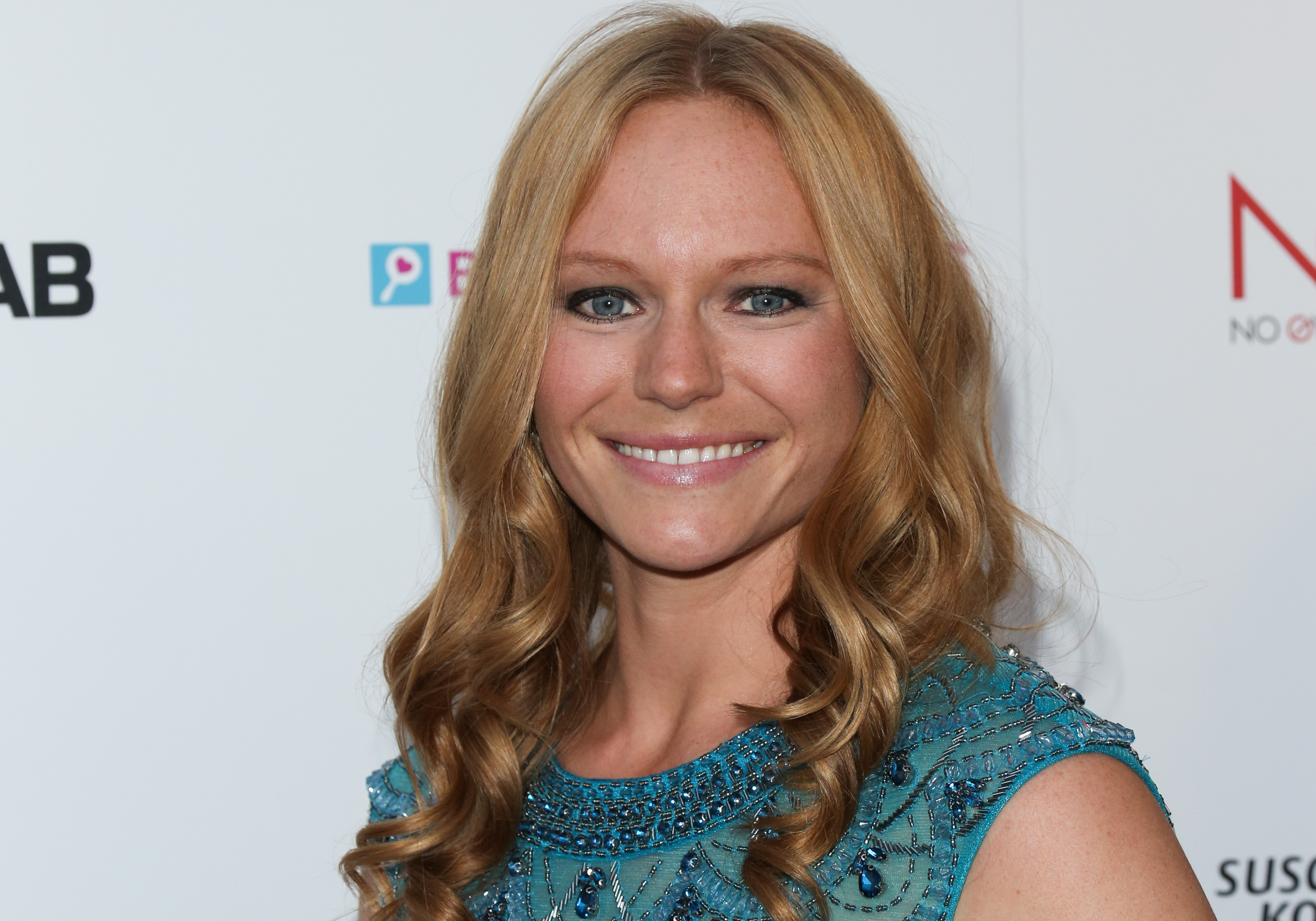 'Days of Our Lives' star Marci Miller wearing a blue dress during a red carpet appearance.