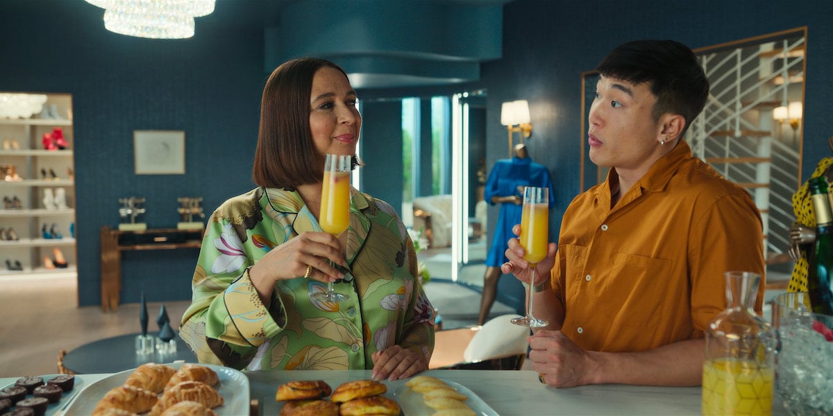 Maya Rudolph and Joel Kim Booster drink orange juice in 'Loot' Season 1 Episode 3: 'Hot Seat'