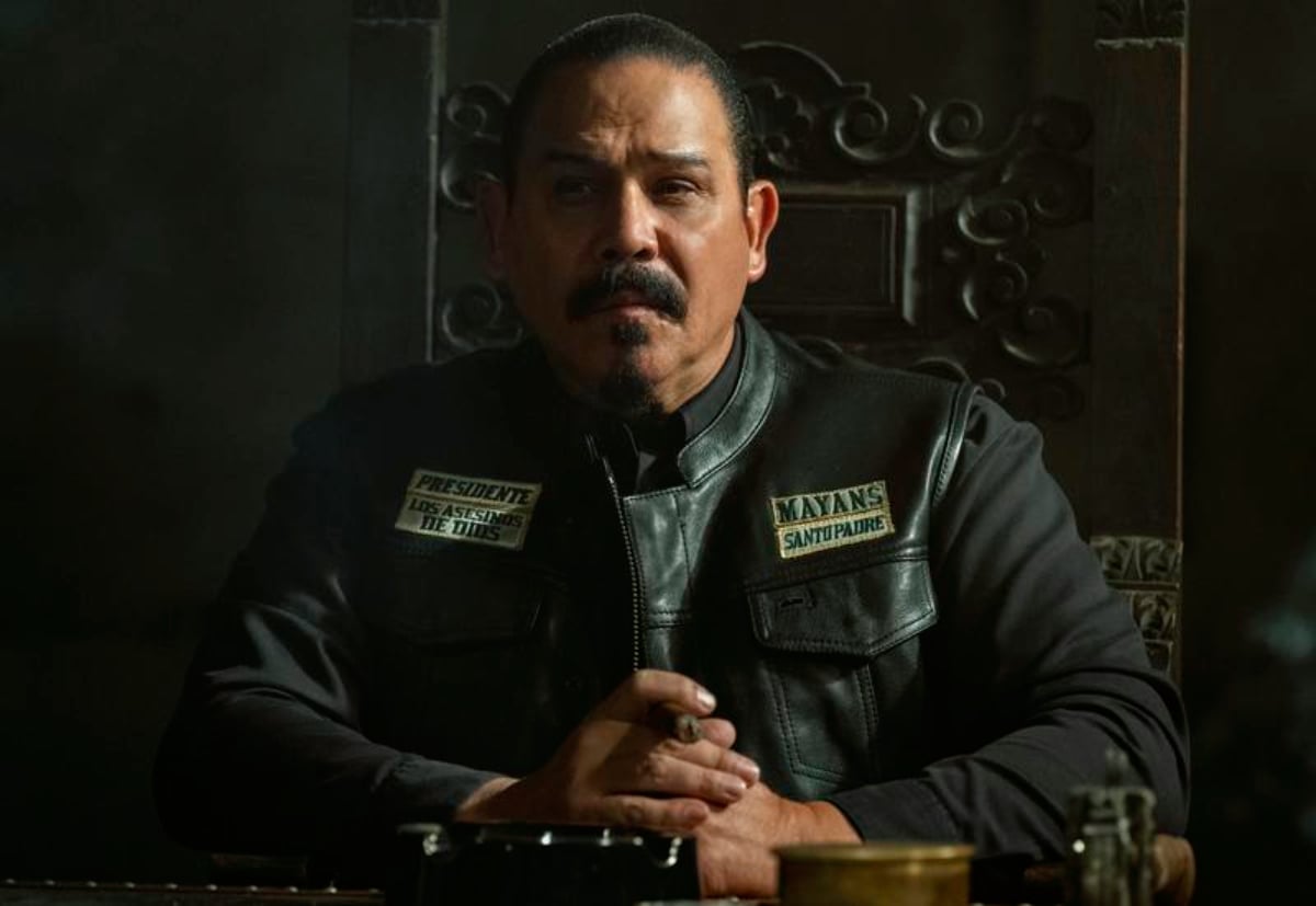 Emilio Rivera as Alvarez in Mayans MC Season 4. Alvarez sits at the head of the table at Templo. 