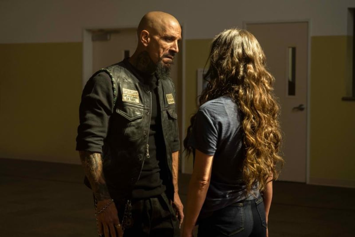 Joseph Lucero as Creeper and Stella Maeve as Kate in the Mayans MC Season 4 finale. Creeper and Katie face each other. 