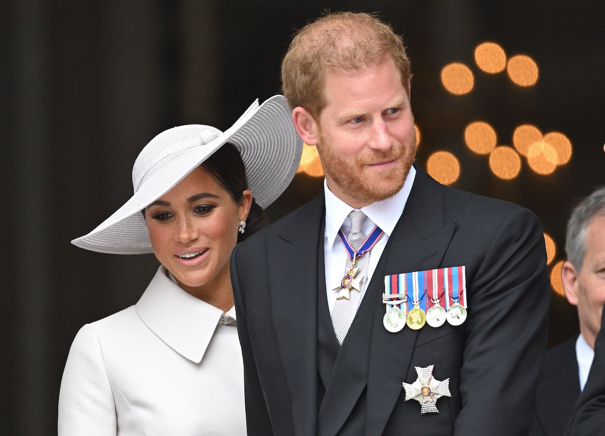 Meghan Markle and Prince Harry, who had Lili's first birthday cake made by Claire Ptak, smile and look on  