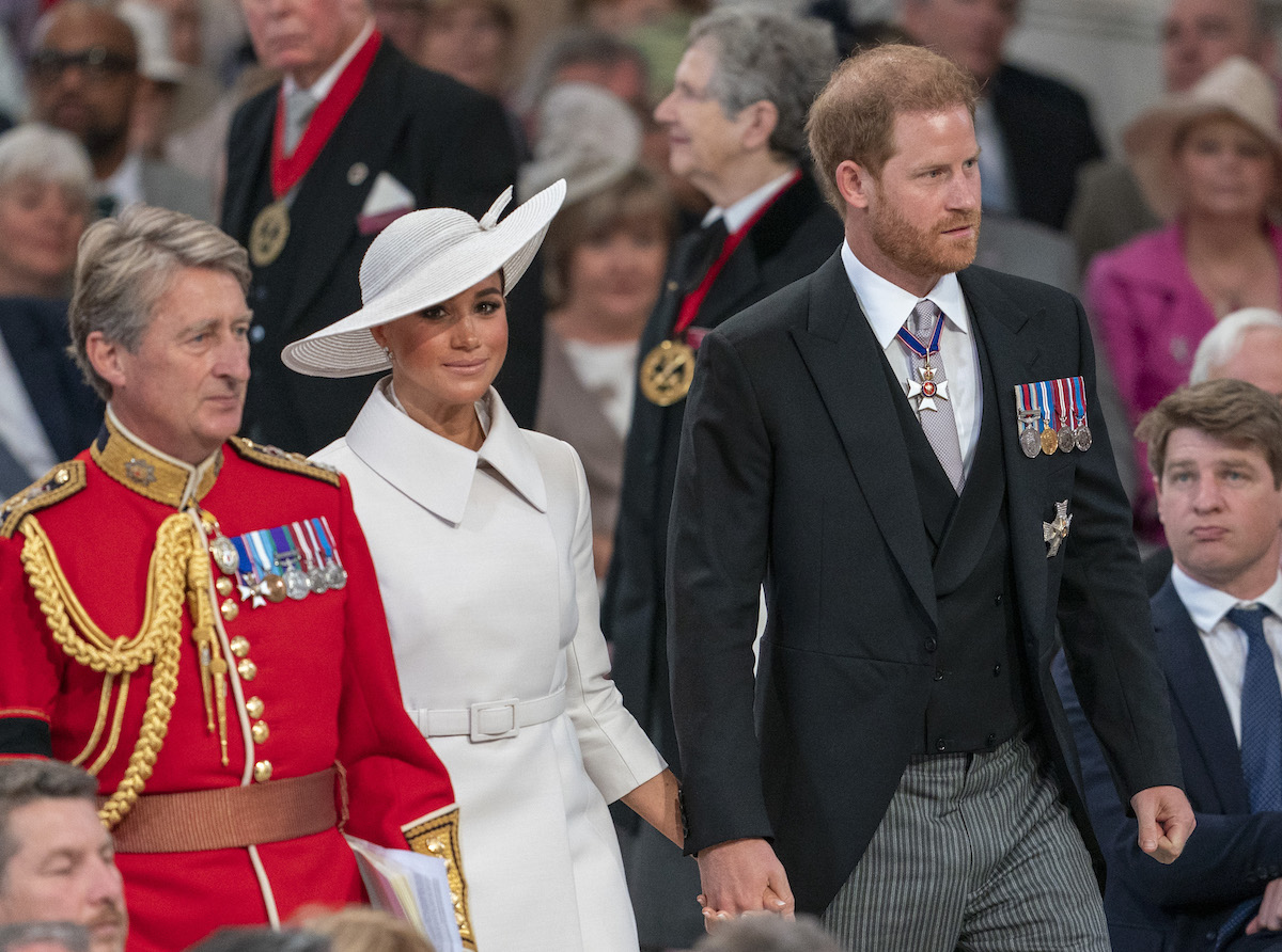 Meghan Markle and Prince Harry, who a royal commentator says probably wasn't furious about sitting in the second row at St. Paul's Cathedral, walks the aisle