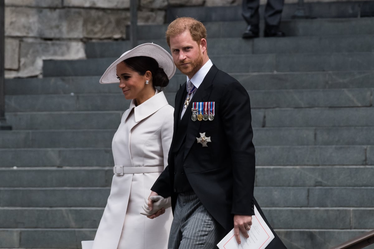 Meghan Markle and Prince Harry, who didn't attend the Platinum Jubilee pageant because of seating, according to a royal expert, walk the steps of St. Paul's Cathedral during Platinum Jubilee weekend