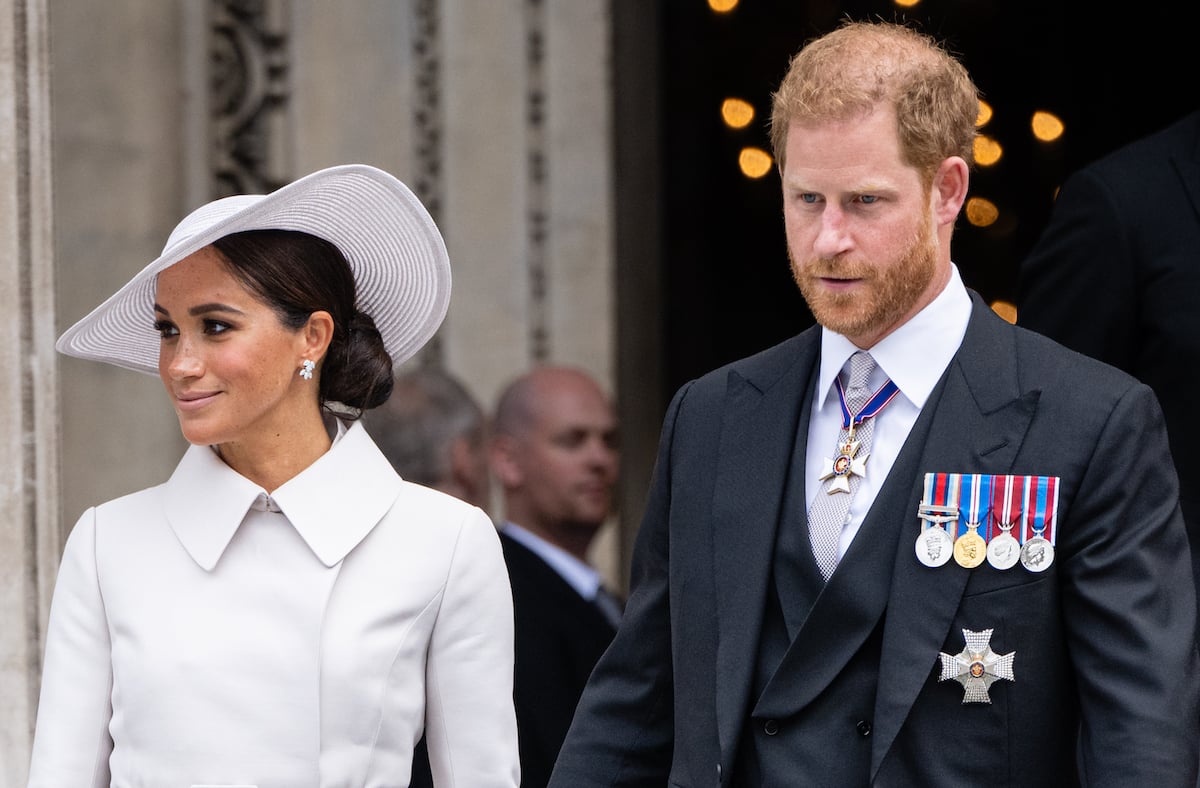 Meghan Markle and Prince Harry, who an expert says had different body language at a church service, look on as they exit St. Paul's Cathedral 