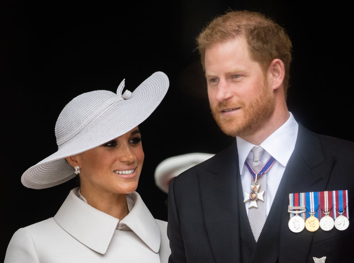 Meghan and Prince Harry, who shared a Lili first birthday portrait, smile and look on