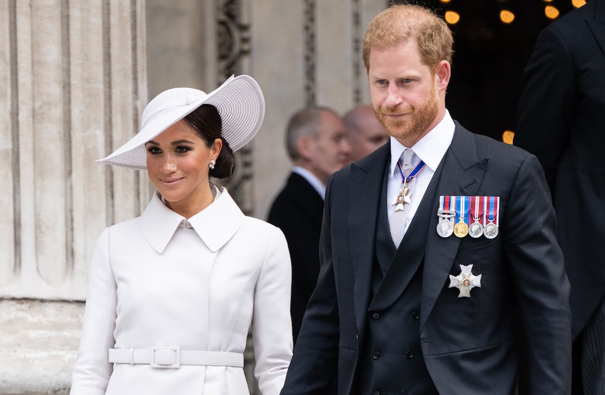 Meghan Markle and Prince Harry, who didn't share a photo of Queen Elizabeth and Lili, smile as they exit St. Paul's Cathedral