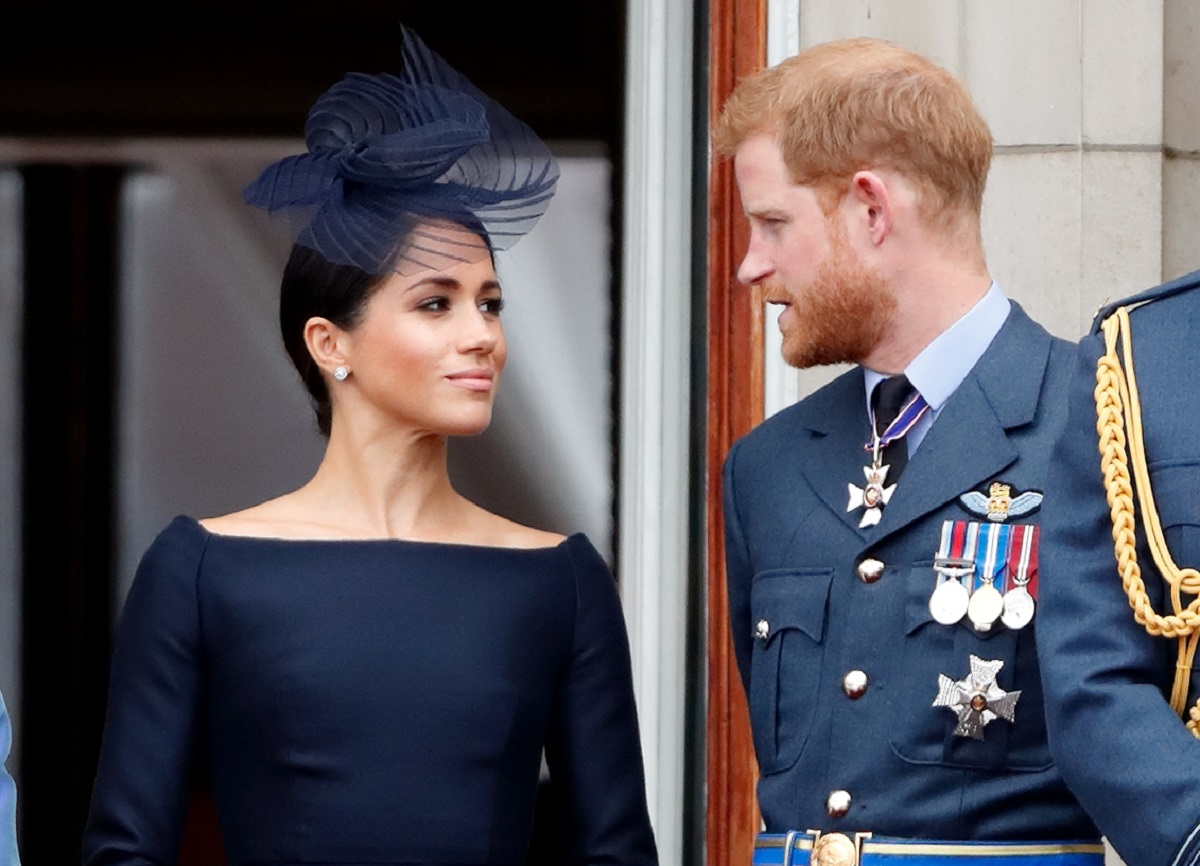 Meghan Markle glares at Prince Harry while standing on the Buckingham Palace balcony during flypast in 2018