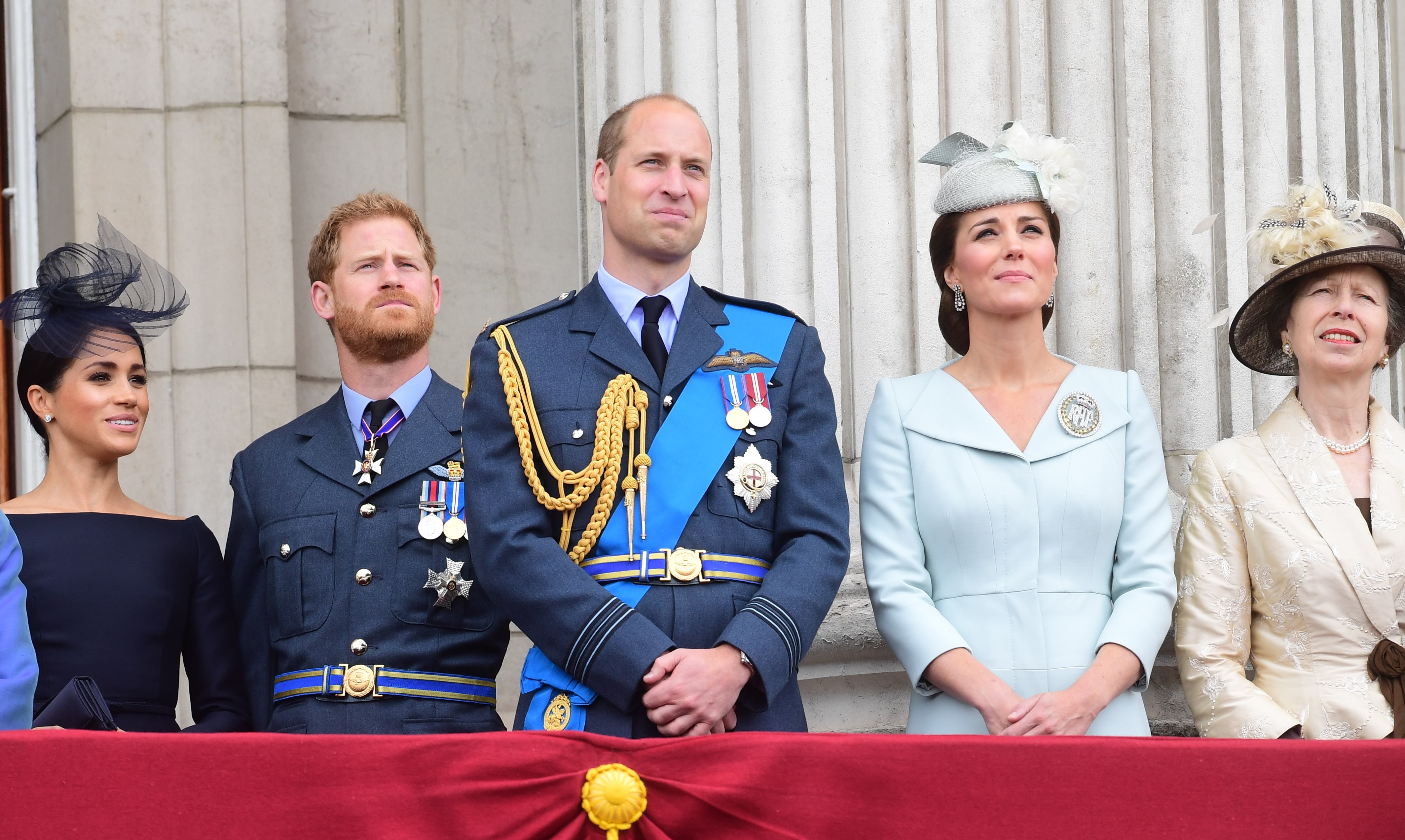 Members of the royal family standing on the balcony of Buckingham Palace for a flypast