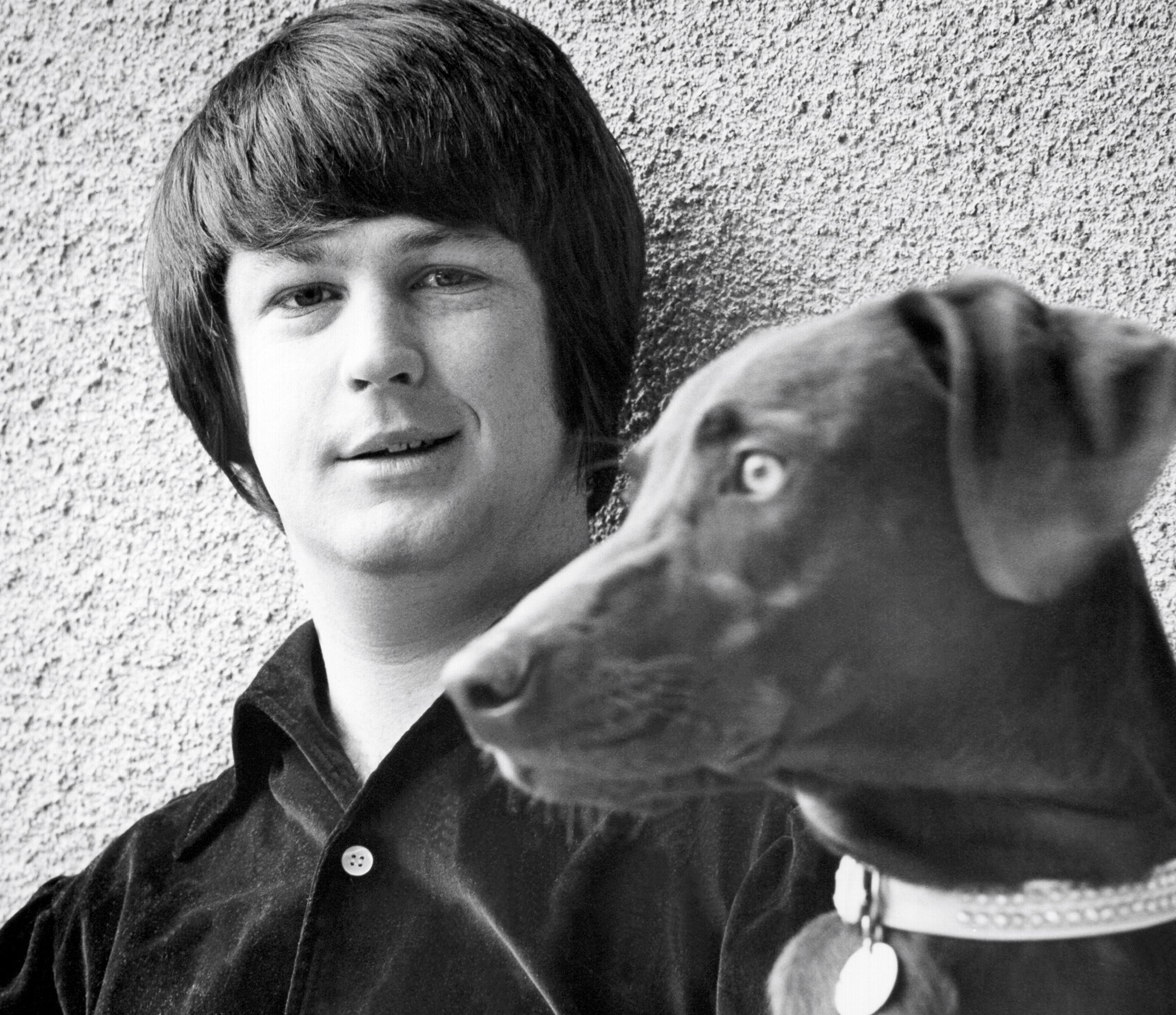 The Beach Boy's Brian Wilson next to a dog