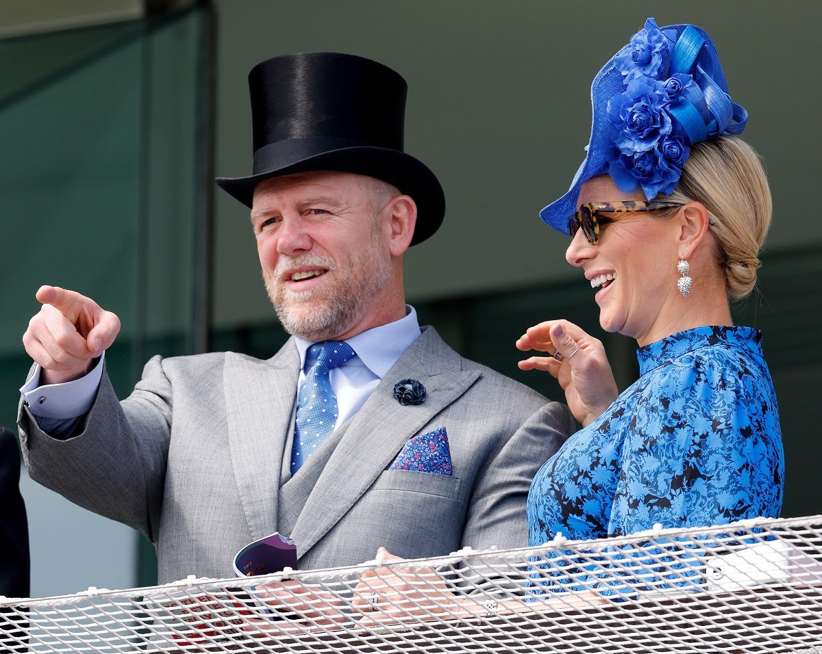 Mike Tindall pointing as he and Zara Tindall watch the racing from the royal box
