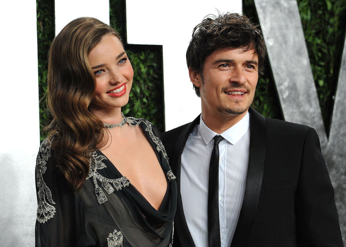 Then-couple Miranda Kerr and Orlando Bloom pose on the red carpet at the 2013 Vanity Fair Oscar party