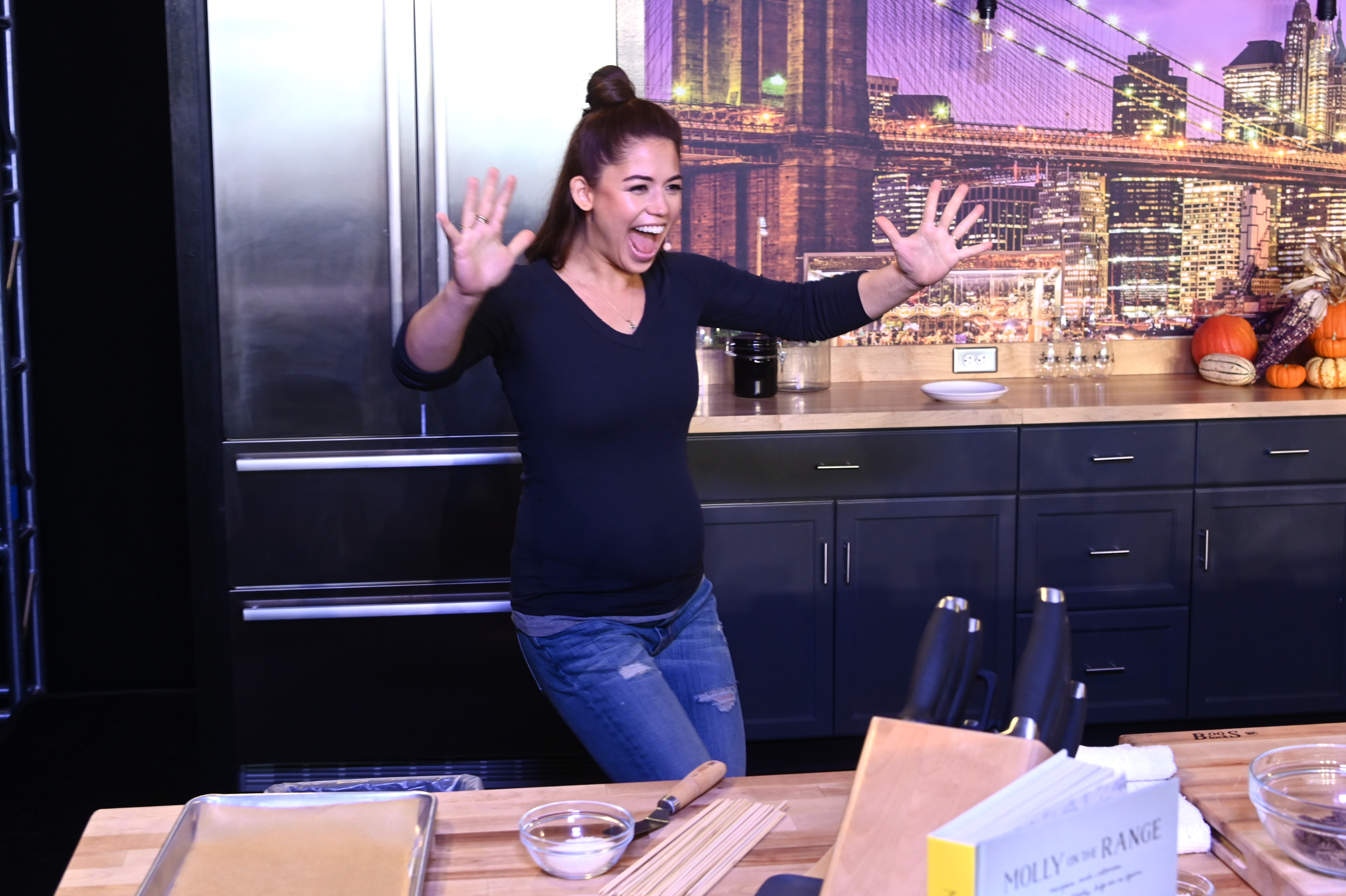Celebrity chef Molly Yeh wears a blue sweater and blue jeans in this photograph.