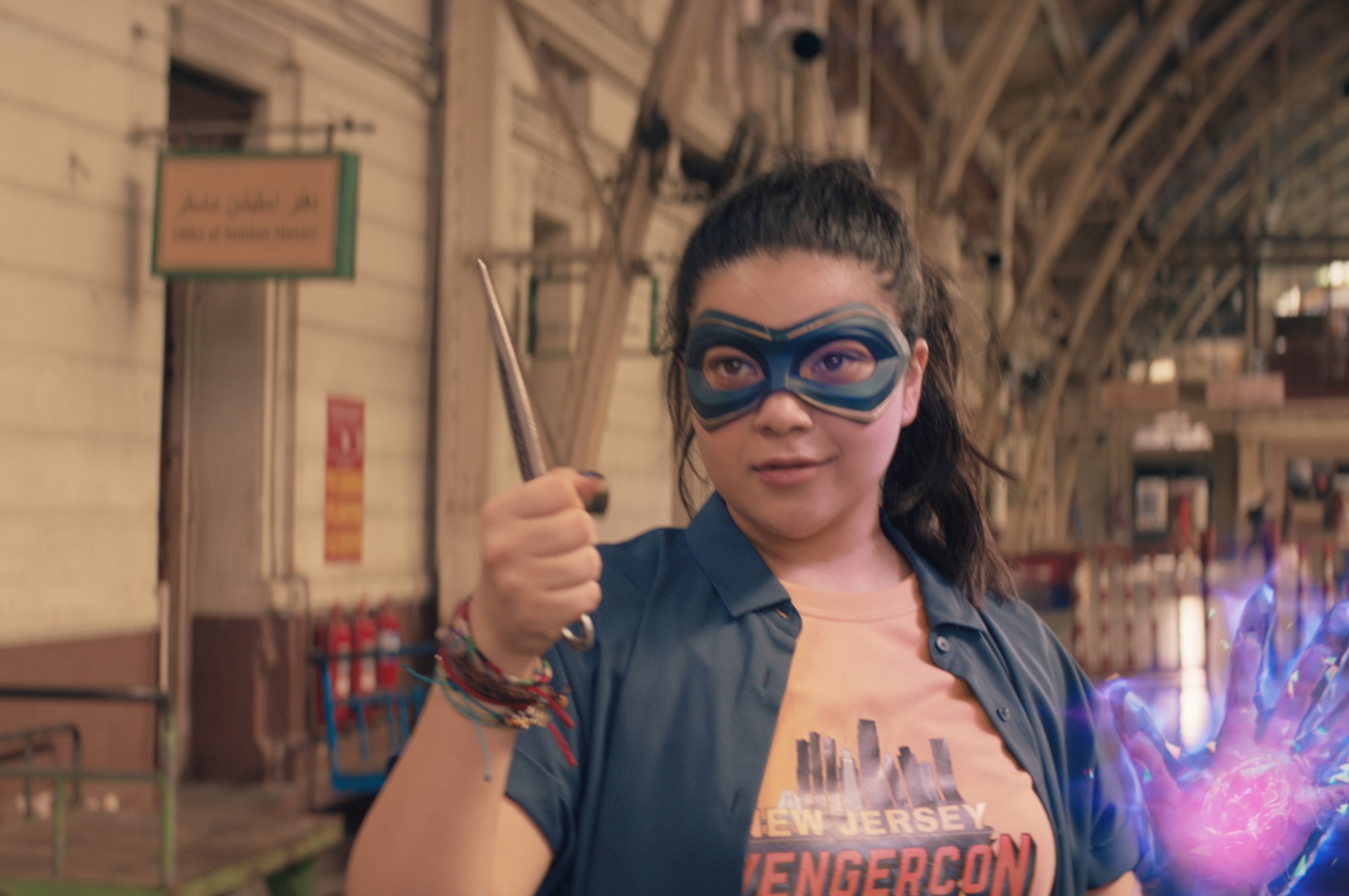 Iman Vellani as Kamala Khan in 'Ms. Marvel,' which has an episode 5 release date of July 6. She's wearing a blue mask, and her hand is glowing.