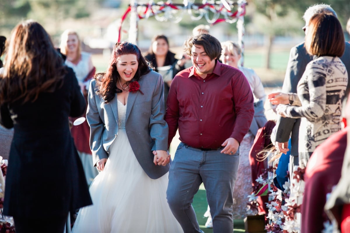 Mykelti Brown walking down the aisle, holding hands with her husband, Tony Padron, during their wedding day as captured on 'Sister Wives' on TLC.