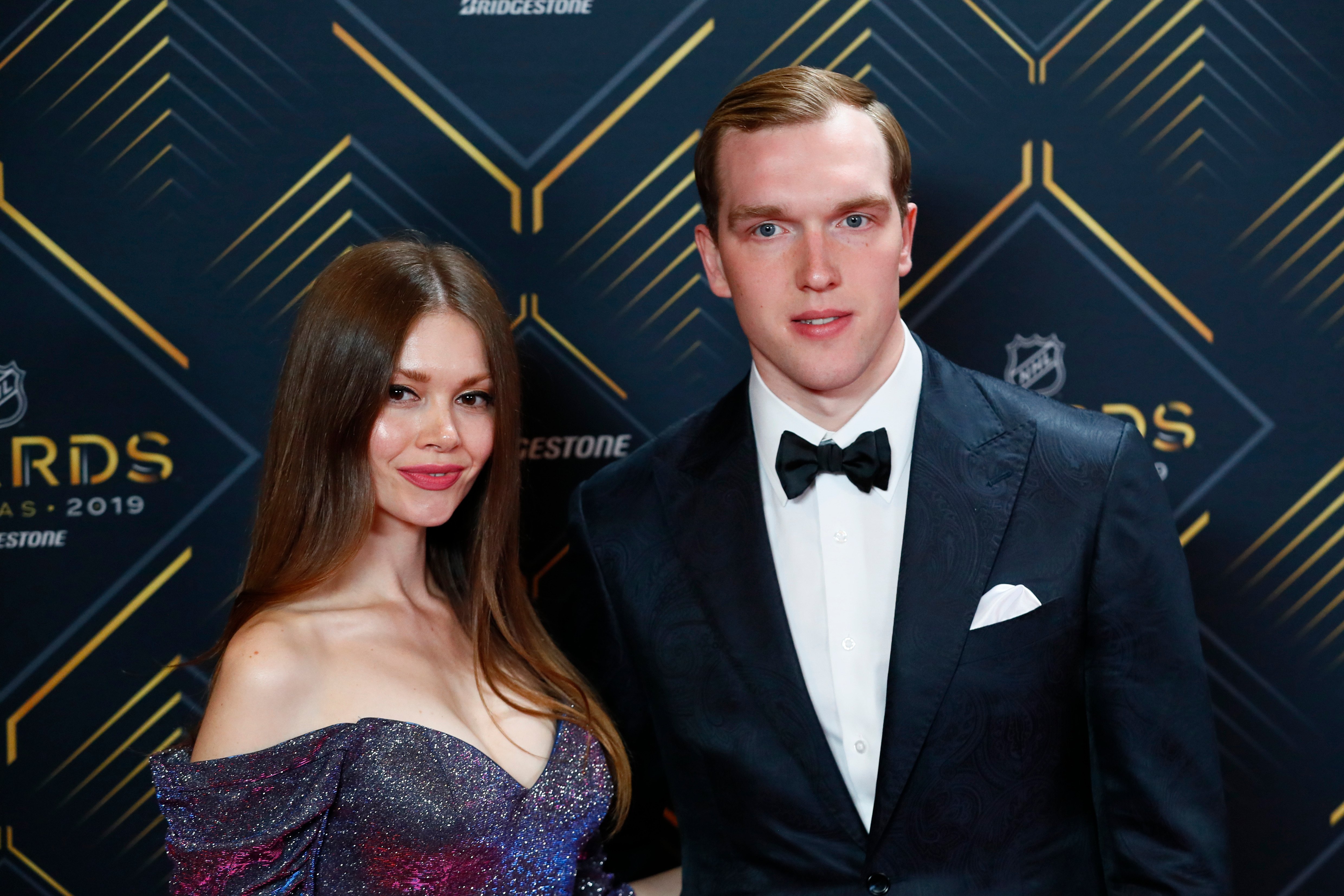 NHL goalie Andrei Vasilevskiy poses for photos on the red carpet with his wife, Kseniya Vasilevskaya