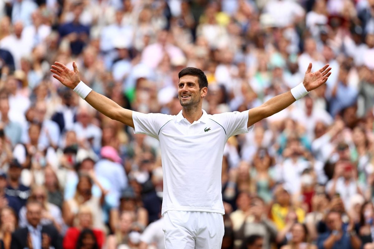 Novak Djokovic celebrates with his arms extended after winning a men's Singles Final match
