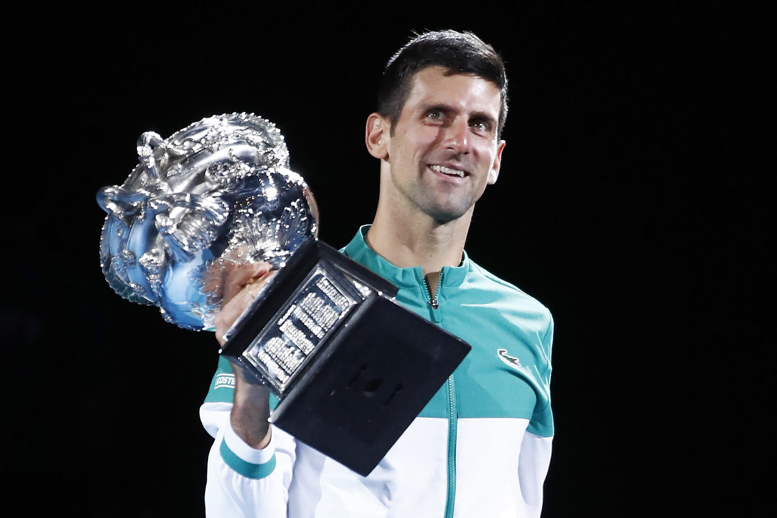 Novak Djokovic, who owns mansion around the globe, celebrating his victory holding the Norman Brookes Challenge Cup