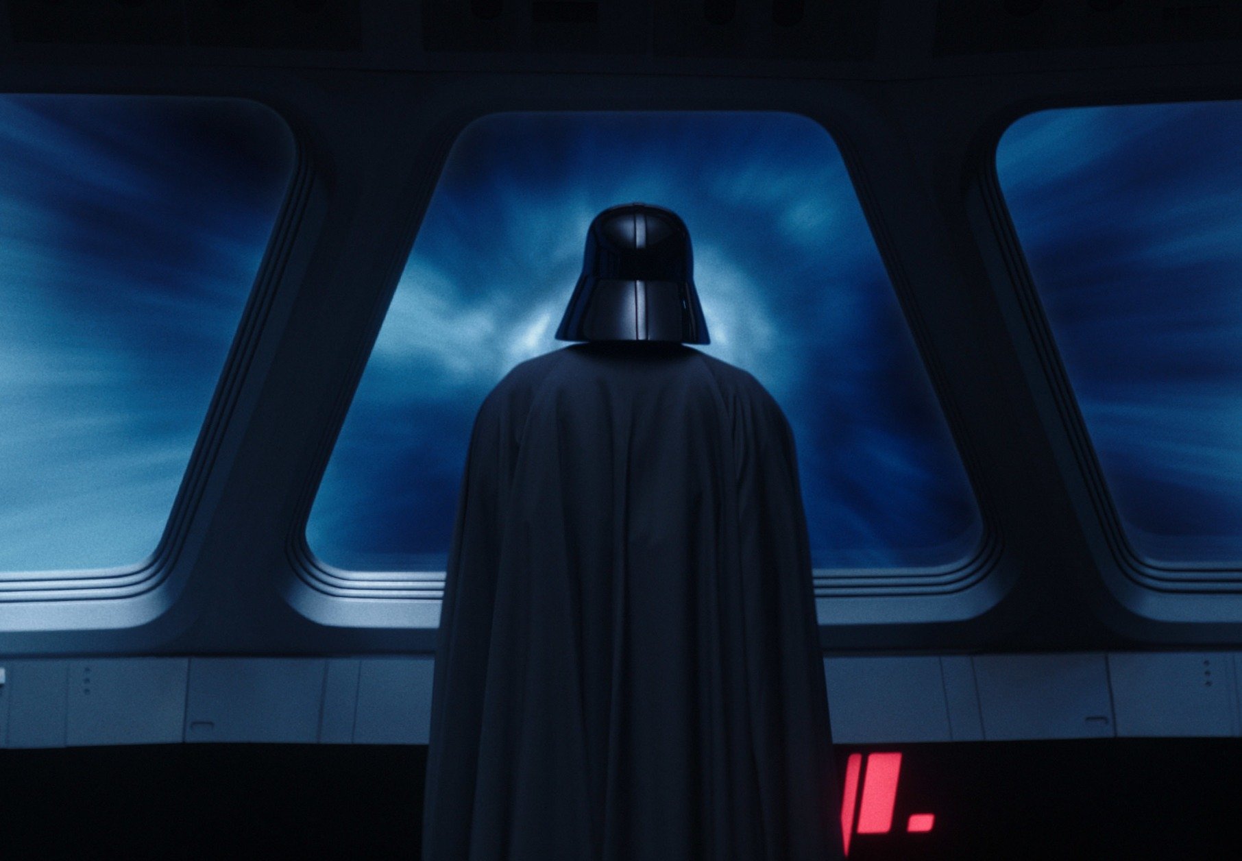 Hayden Christensen as Darth Vader in 'Obi-Wan Kenobi,' which has an episode 6 release date of June 22. He's standing at the front of a ship and looking out windows to a blue sky.