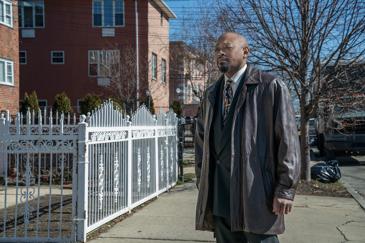 Omar Epps as Detective Malcolm Howard standing on the sidewalk wearing a large leather coat in 'Power Book III: Raising Kanan'