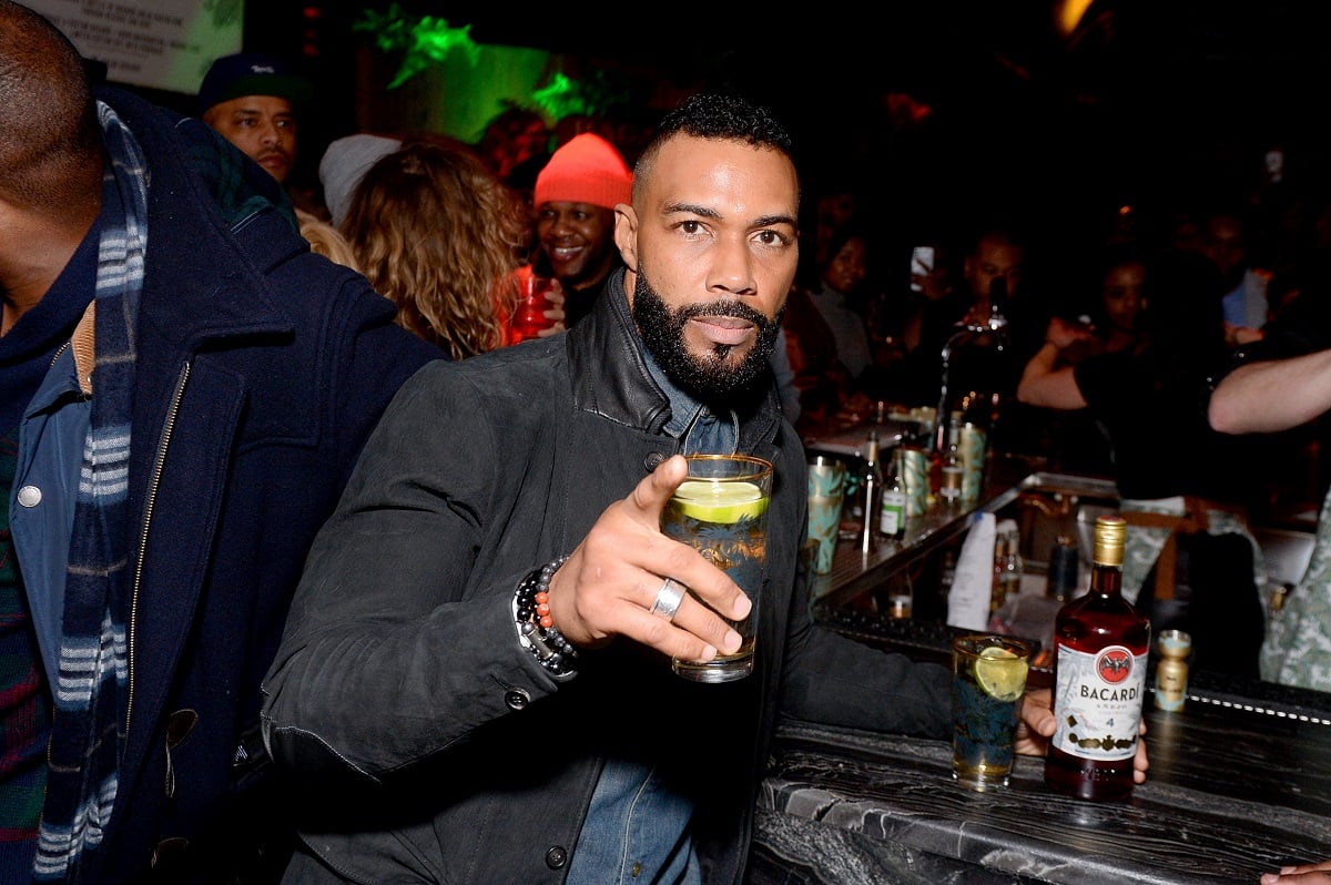 Omari Hardwick posing in a suit.